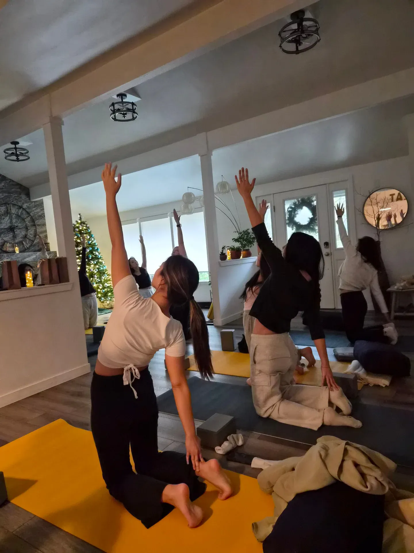 Guests practicing gentle yoga together in a bright studio space